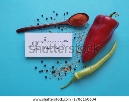 Structural chemical formula of capsaicin molecule with chili peppers, chili powder, and peppercorns. Capsaicin is the compound found in chili peppers that gives them their hot and spicy kick.