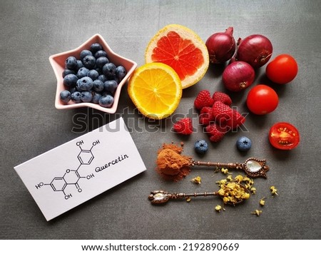 Structural chemical formula of quercetin molecule with fresh fruit and vegetable. Quercetin is a plant pigment (flavonoid). It's found in many plants and foods such as red onions, berries, tomatoes...