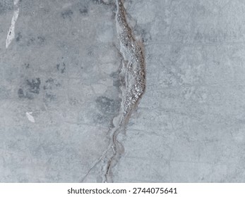structural damage on the surface of concrete or cement in the form of cracks that are quite deep and wide 