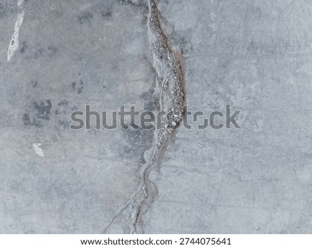 structural damage on the surface of concrete or cement in the form of cracks that are quite deep and wide 