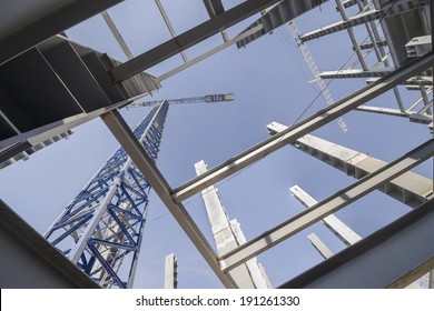 Structural design and jib crane Low-angle shot of a several metal columns and girders of a construction site 