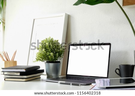 Structural engineer and architect desktop with blank screen laptop and safety helmet