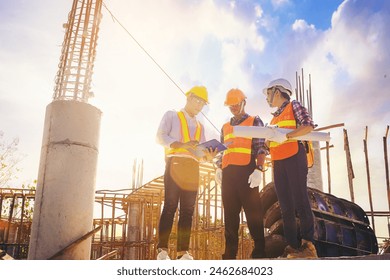 Structural engineer or architect and foreman worker with blueprints discuss, plan working for the outdoors building construction site. Construction collaboration concept - Powered by Shutterstock