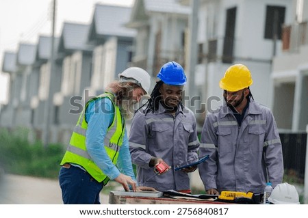 Structural engineer and foreman worker with touch pad discuss, plan working for the outdoors building construction site. civil engineer or architect on construction site