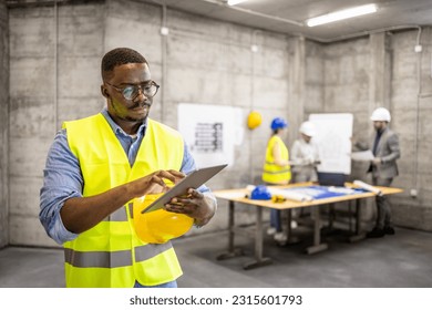 Structural engineer working on digital tablet at construction site. - Powered by Shutterstock - Get 15% off with code: PIKWIZARD15
