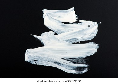 Structural paint white on a black background. paint to smear.
