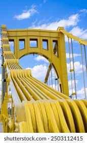 Structural view of Roberto Clemente Bridge against blue sky in Pittsburgh, Pennsylvania.