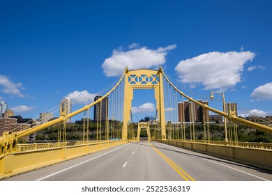 Structural view of Roberto Clemente Bridge against blue sky in Pittsburgh, Pennsylvania.