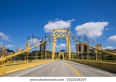 Structural view of Roberto Clemente Bridge against blue sky in Pittsburgh, Pennsylvania.