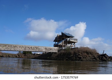 Structure by river with bridge