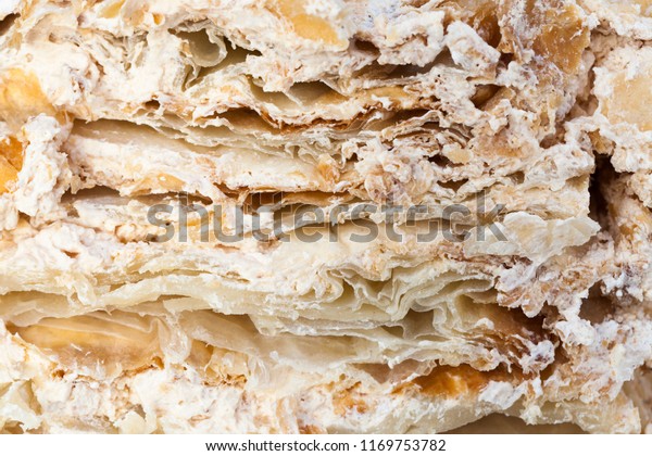 the structure of a cut cake with a layered\
structure with a cream of brown color, divided into pieces during\
the celebration of the\
wedding