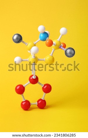Structure of molecule on yellow background. Chemical model