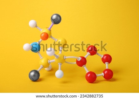Structure of molecule on yellow background. Chemical model