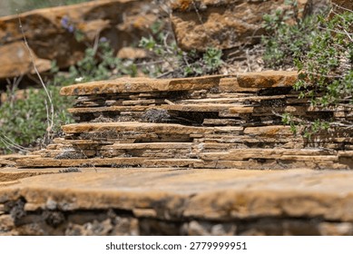 Structure of mountain formations consisting of many flat stone plates. Types of stone structures. Different types of rocks. Petrology or petrography. Study of mountain formations