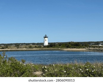 The structure pictured in the image is the Edgartown Harbor Lighthouse, Located in Edgartown, Massachusetts. Situated on the eastern end of the island of Martha's Vineyard, It marks the entrance to Edgartown Harbor and Katama Bay. Near Boston and Cape Cod.