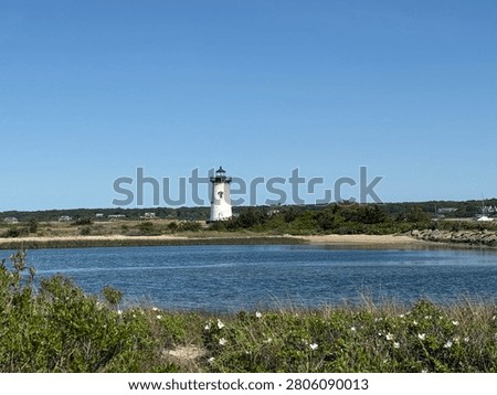 The structure pictured in the image is the Edgartown Harbor Lighthouse, Located in Edgartown, Massachusetts. Situated on the eastern end of the island of Martha's Vineyard, It marks the entrance to Edgartown Harbor and Katama Bay. Near Boston and Cape Cod.