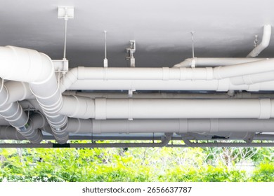 Structure plastic pipes under building or apartment. Plumbing rough-in or electrical conduit in commercial building with pvc pipe in construction site of apartment.