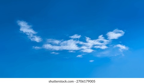 Structure of some cloud on the blue sky. White relaxed cottony form. Background serene sky. Fiber contours after rain. Lonely substance of water.