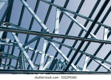 Structure Of Steel Roof Frame For Building Construction On Sky Background.