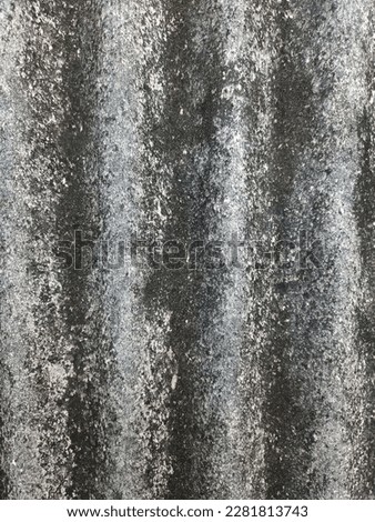 The structure of a tile made of cement with a mixture of gray and black due to eroding over time.