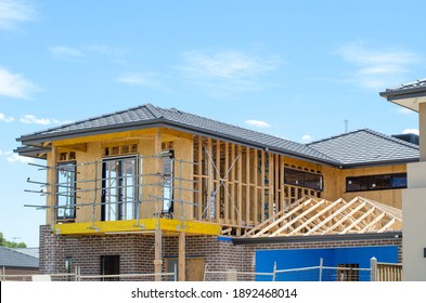 The structure of a two-story residential suburban house under construction. Concept of real estate development, self build a home, new Australian suburb, and homeownership. Melbourne, VIC Australia.