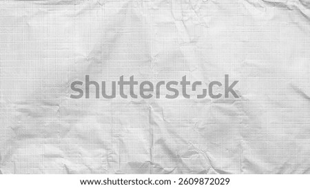 Structured foil texture background in soft light showcasing intricate creases and reflections.