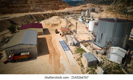 Structures Of Plant Producing Sand, Crushed Stone, Cement And Batching Concrete And Asphalt. Mixer Trucks, Concrete Pumping Machines, Gas Tanks And Silos Aerial View. Construction Materials Production