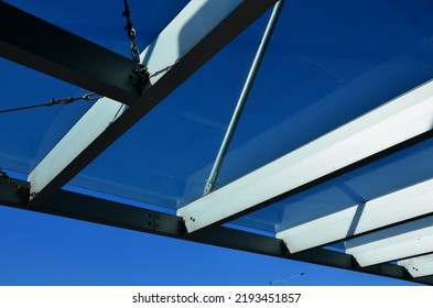 Strut, Suspended Glass Roof Above The Building Entrance. Bus Station, Railway Station. Cable Wind Braces. Aluminum Construction With Windows Above The Pergola