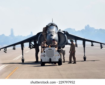 STUART - NOVEMBER 1: Crews guide US Marines Harrier jetfighter on a tarmac in Stuart, Florida on November 1, 2014. AV-8 Harriers can take off and land vertically.
