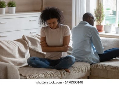 Stubborn African American Husband And Wife Sit On Couch Back To Back Avoid Talking After Fight, Mad Offended Biracial Couple Have Family Dispute Or Argument Ignore Each Other, Divorce Concept