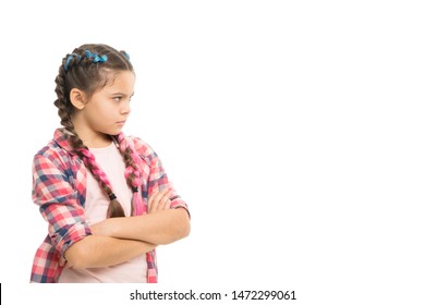 Stubborn child. Disagreement and stubbornness. Girl serious face offended. Kid looks strictly. Girl folded arms on chest looks serious copy space white background. Stubborn temper. Stubborn concept.