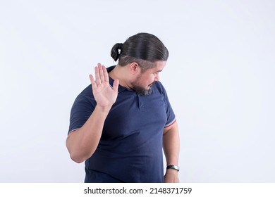 A stubborn man in his 30s refuses to listen, looking away. Isolated against a white background.