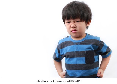 Stubborn, sad, upset little Asian boy isolated over white background.Facial expression.