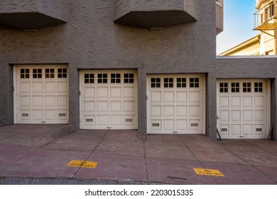 Stucco Building With Four Garage Doors Going Down Hill In San Francisco