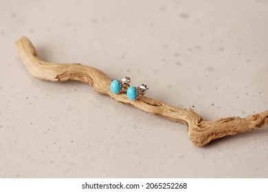 Stud earrings made of natural turquoise sleeping beauty. Designer earrings from natural turquoise stones. Women's jewelry on a light background and wood. Author's modern jewelry. - Shutterstock ID 2065252268