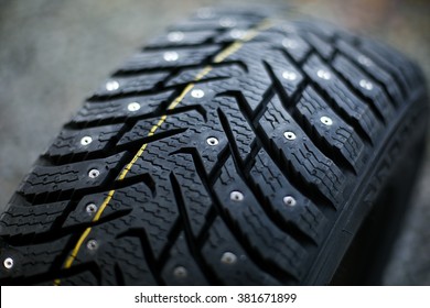 Studded Tire On A  Background