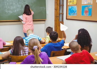 Student about to throw a paper airplane at the elementary school - Powered by Shutterstock