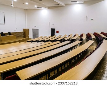 Student amphitheater with semicircular wooden chairs and tables