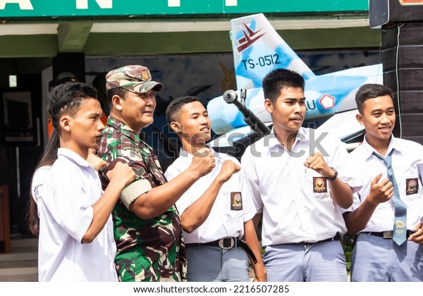 student with an army  at Indonesia National army\
exhibition, medan, october\
2022