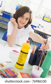 Student In Art Class With Paints