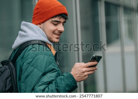 student with backpack and mobile phone