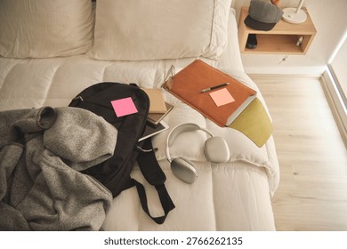 Student backpack and study essentials lying on a bed, ready for new academic challenges