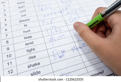 Student With A Bad Handwriting Writing Irregular Verbs