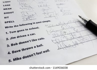Student With A Bad Handwriting Writing Irregular Verbs