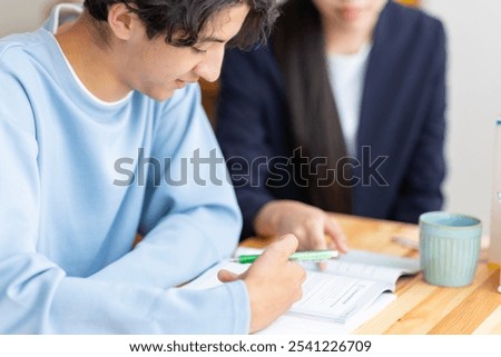 A student being taught to study by a tutor