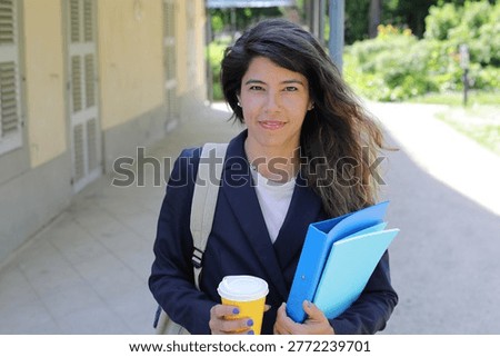 Student with binder and coffee