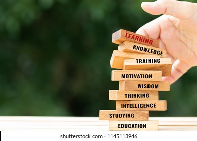 Student Blur hand placing Sign wooden blocks tower and space for letter e.g education, learning, motivation, studying etc. Ideas goal study to success in life and business. Back to School