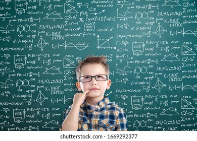 Student boy on blackboard background with formulas - Powered by Shutterstock