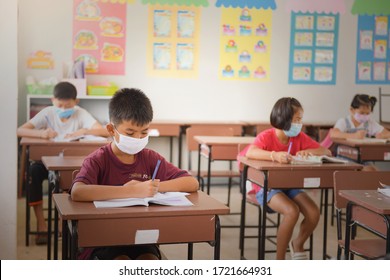 Student Boy Wear A Mask To Prevent The Spread Of Covid 19 In The Coronavirus Classroom, Seasonal Influenza Pandemic, Colds, Respiratory Epidemic.