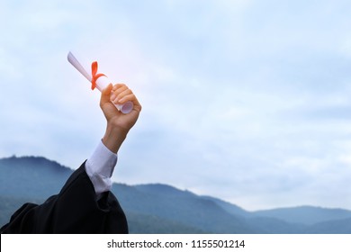 Student With Congratulations, Graduates Wearing A Graduation Gown Of University 